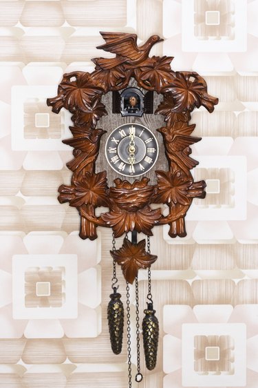 Cuckoo clock hanging on patterned wall