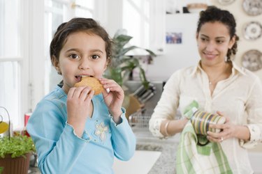 Girl and mother in kitchen