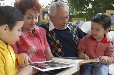 Close-up of a senior couple looking at photographs with their grandsons