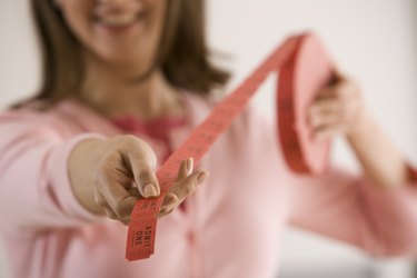 Woman holding roll of admission tickets