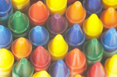 only the tips of colored crayons can be seen at the bottom of the