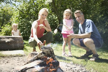 Family gathered around the campfire