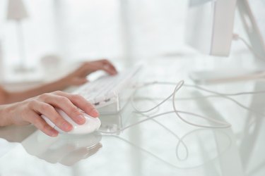 Hands using computer mouse and keyboard