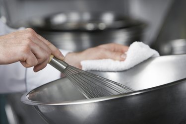 Chef mixing ingredients in bowl close-up