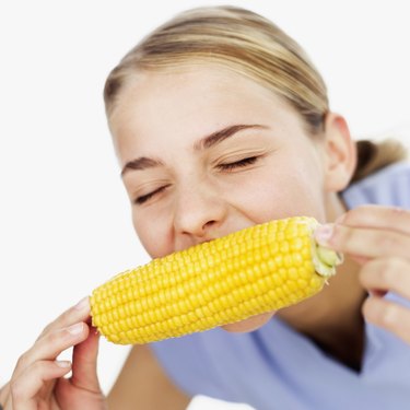 Close-up of a teenage girl (15-17) eating a corncob