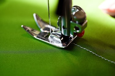 Sewing machine on green fabric
