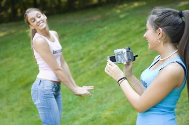 Teen girls with video camera