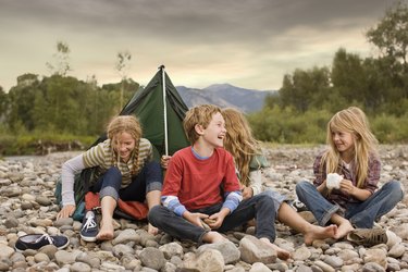 Brother and sisters playing in small tent