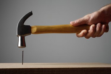 Hand using hammer on nail