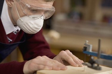 Student using jigsaw in wood shop class