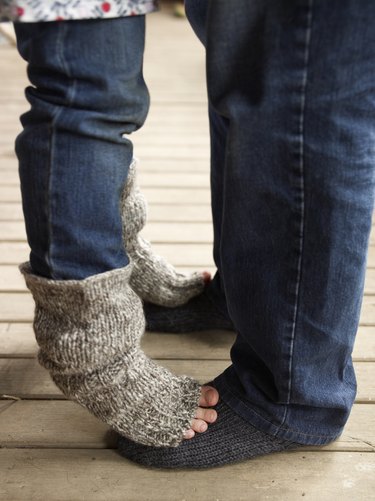 Daughter standing on her father's feet