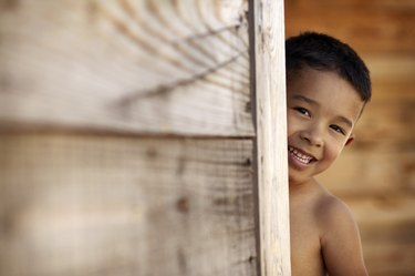 Boy peeking around corner