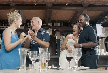 Four friends having fun in a bar together