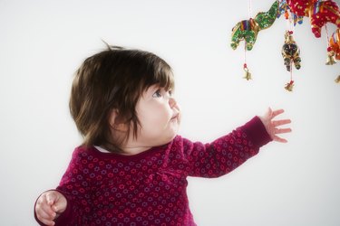 Baby reaching for toy