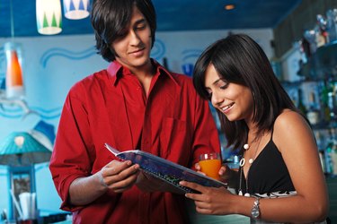 Portrait of a young couple at a bar enjoying