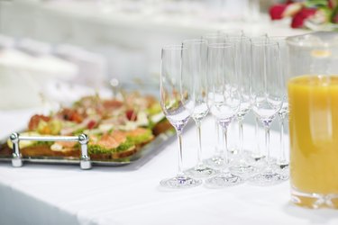 Empty champagne glasses and finger food on festive wedding table