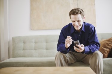 Mid-adult man using PDA