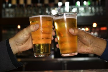 Hands of men toasting with beer