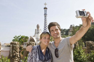 Smiling couple taking a picture, Barcelona, Spain