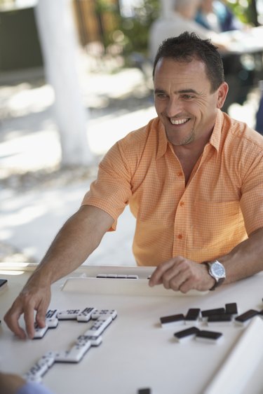 Mature man playing dominos