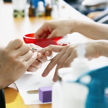 Salon Worker Applying Nail Polish