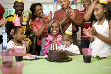 Family giving birthday party to grandmother