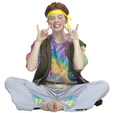 Girl giving peace sign in hippie clothing