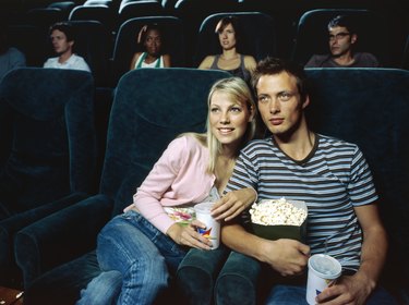 Young couple watching movie in a movie theatre