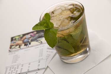 Beverage with mint leaves and horseracing wager cards