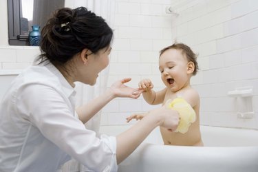 Mother giving son a bath
