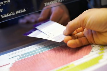 Close-up of hands holding theater tickets