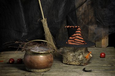 Halloween still live with hat, , broom and cauldron