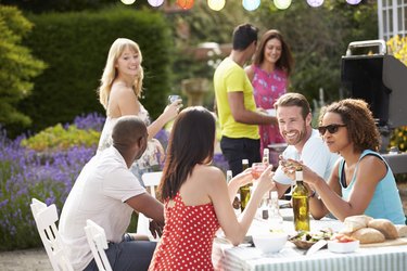 Group Of Friends Having Outdoor Barbeque At Home