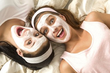 Crazy girls with facial mask lying bed