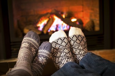 Feet warming by fireplace