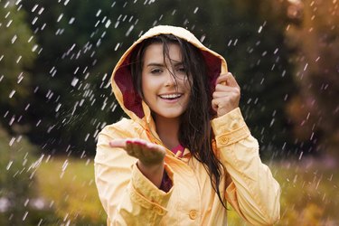 Pretty young woman in yellow raincoat