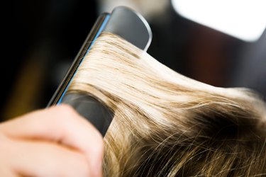 Client having hair straightened