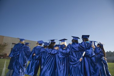 Back view of teenagers wearing cap and gowns