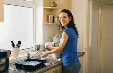 Woman washing paintbrushes