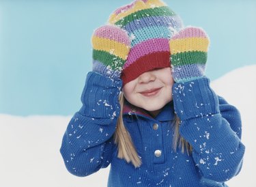 Studio Portrait of a Young Girl Hiding Under Her Woolen Hat