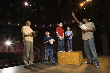 Teacher and students practicing a play