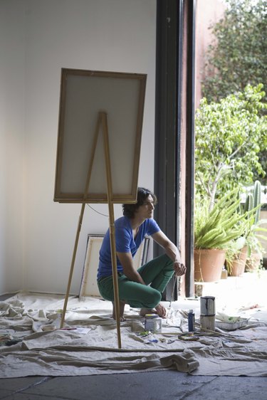 Artist painting with easel