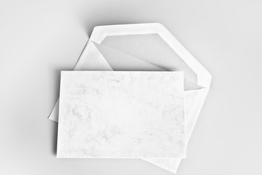 Blank card and envelope over gray background