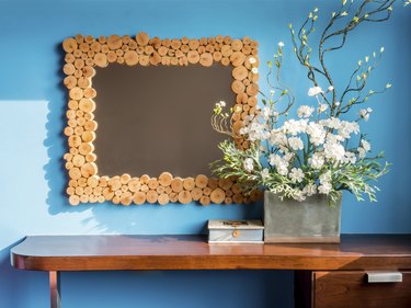 Colourful modern interior wall with artificial flowers in cerami