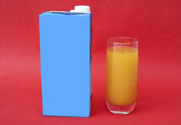 glass and package of mango juice