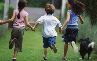 Boy (10-11) running with two girls (11-12)