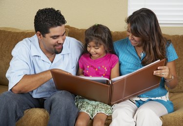 Hispanic family looking at photo album