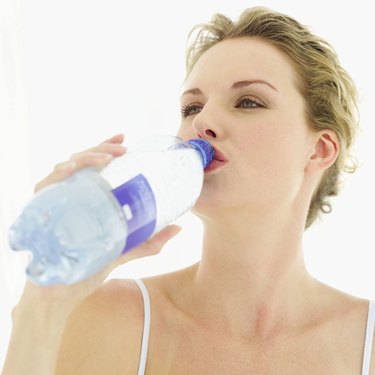 close-up of a woman drinking water from a bottle