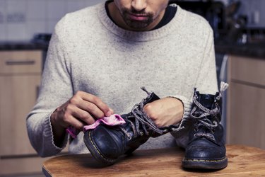 Man is polishing his boots