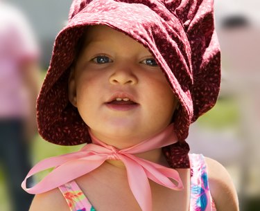 Portrait of little girl in 'pioneer' bonnet